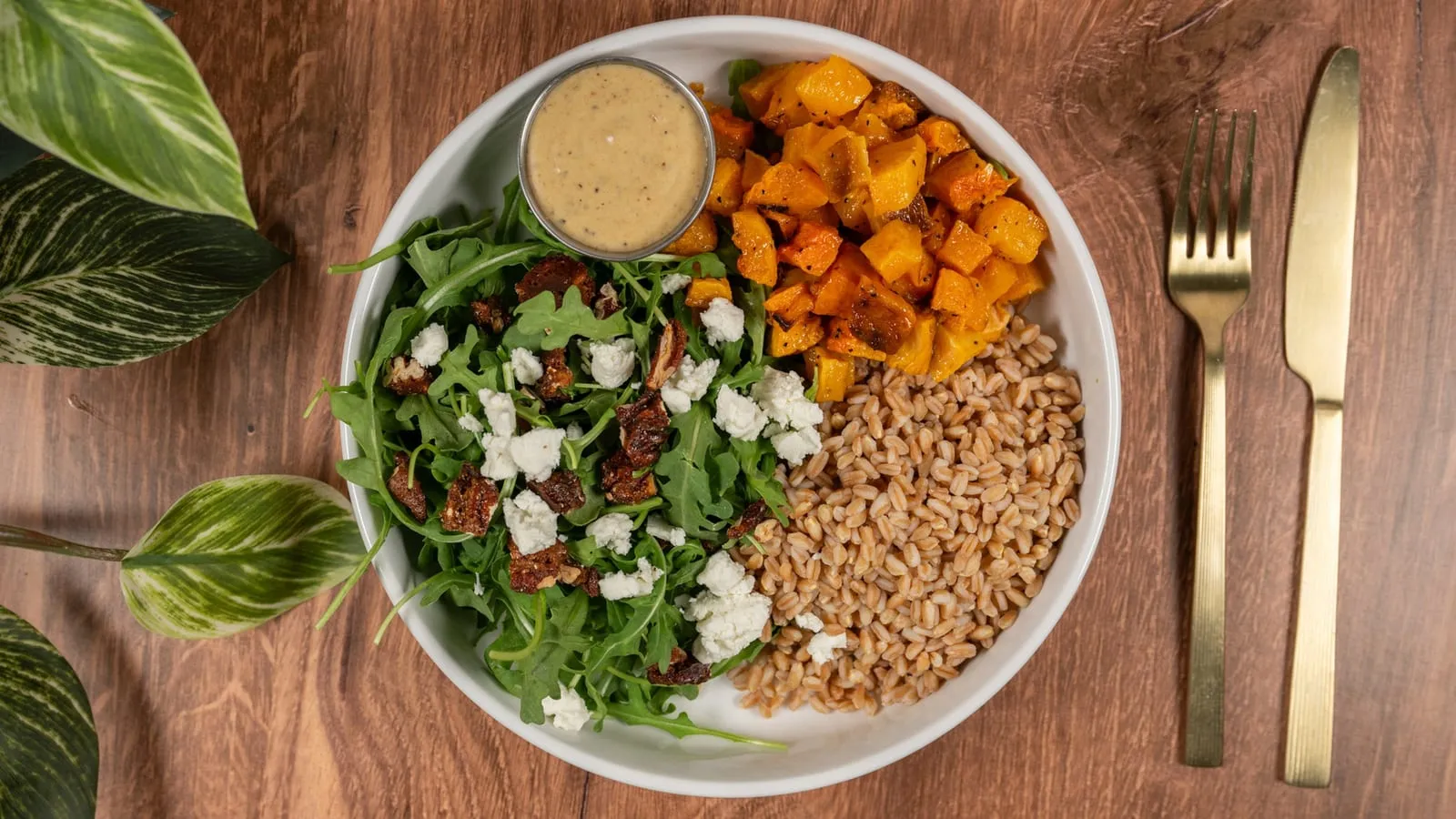 Grain bowl with farro, roasted butternut squash, arugula, and goat cheese
