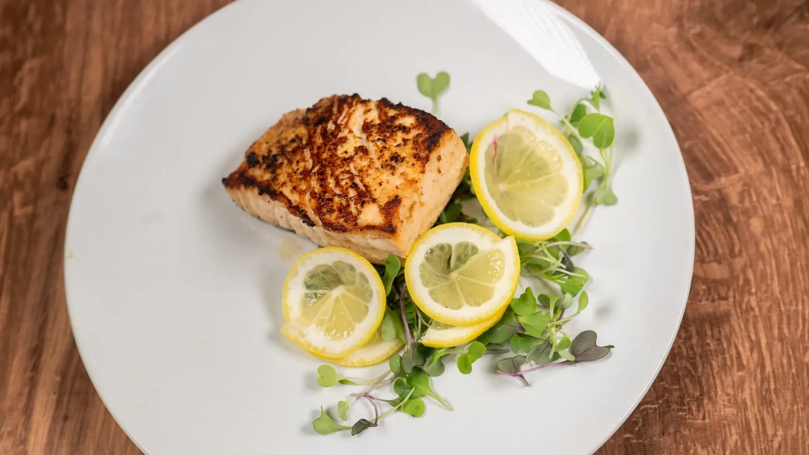 Seared salmon with lemon and microgreens